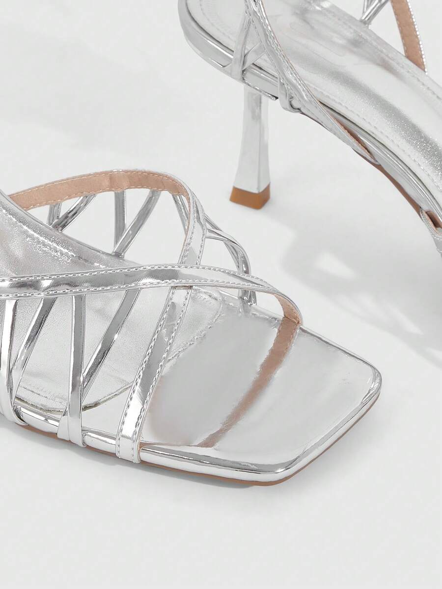 Women's open toe stiletto heel sandals featuring square toe design, criss-cross rhinestone slim straps, and secure ankle strap.