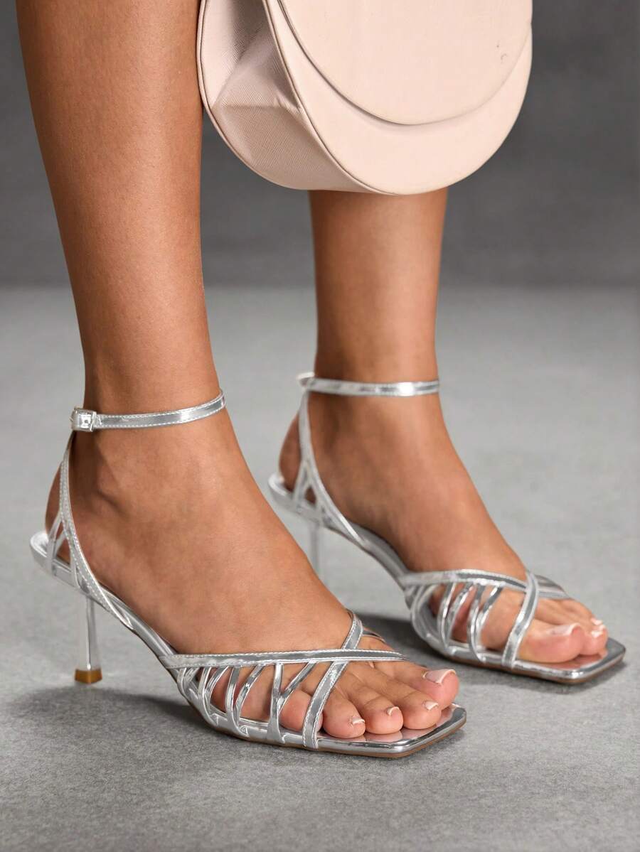 Women's open toe stiletto heel sandals featuring square toe design, criss-cross rhinestone slim straps, and secure ankle strap.