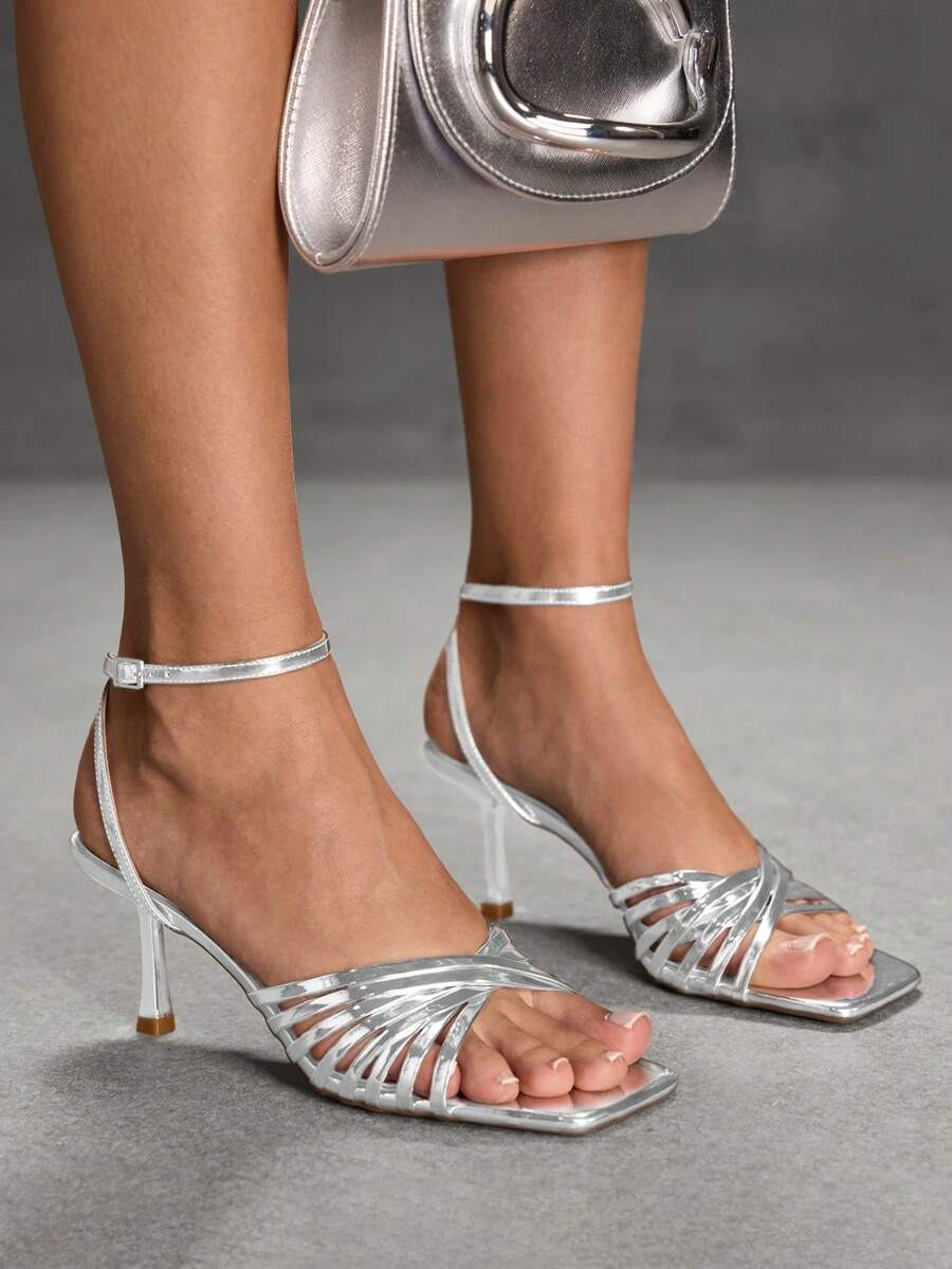 Women's open toe stiletto heel sandals featuring square toe design, criss-cross rhinestone slim straps, and secure ankle strap.