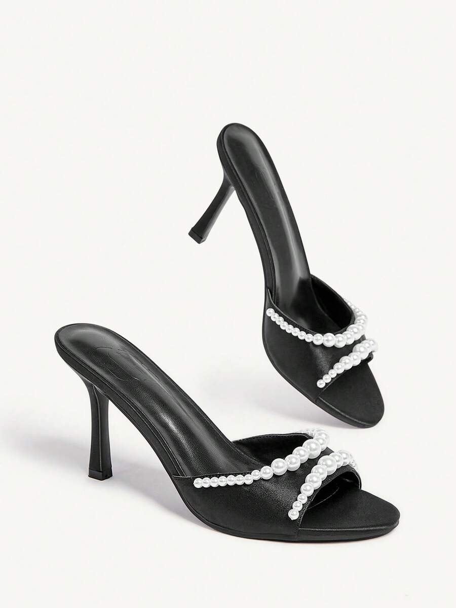 Elegant women's satin high heel sandals with pearl embellishments, stiletto heels, and slingback straps for bridal and wedding wear.