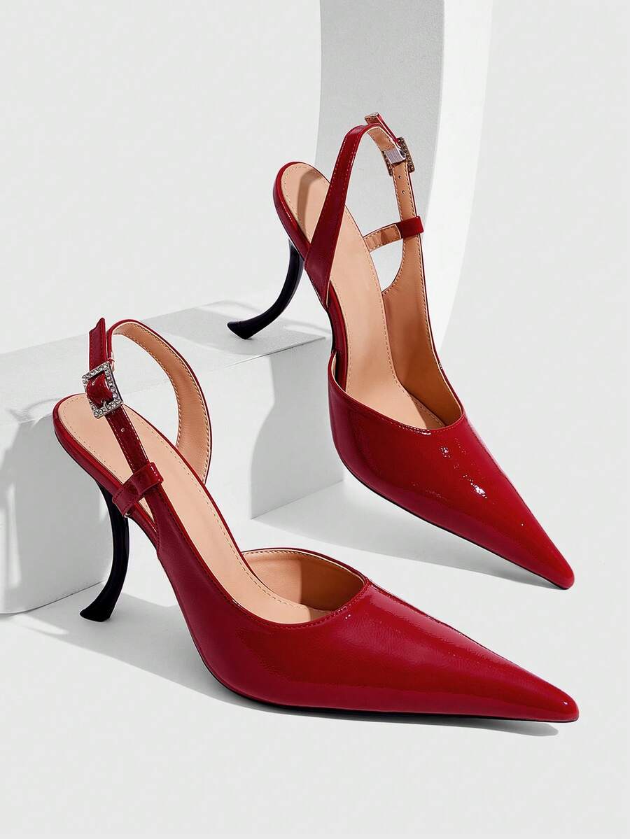 Red women's pointed-toe high heel sandals featuring a sculptural heel, rear slingback strap, and decorative buckle detail.
