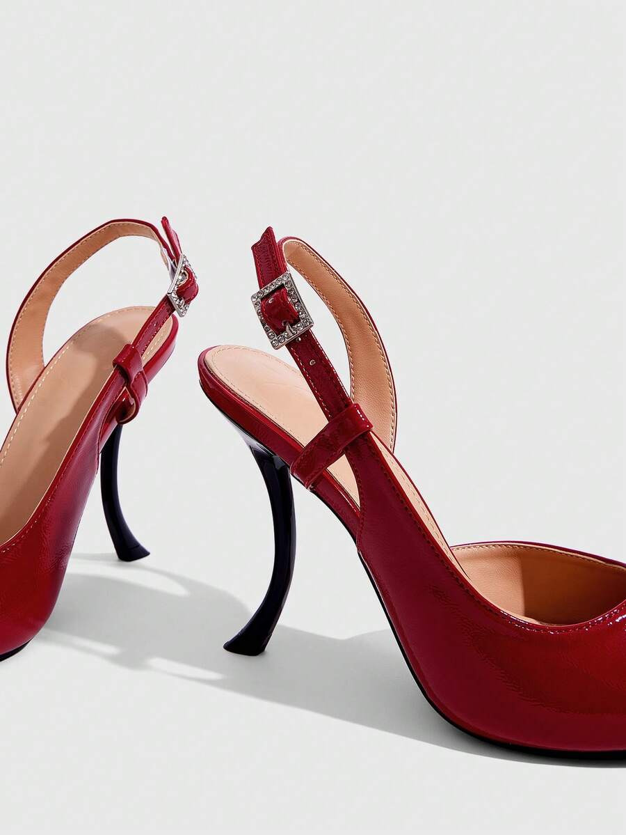 Red women's pointed-toe high heel sandals featuring a sculptural heel, rear slingback strap, and decorative buckle detail.