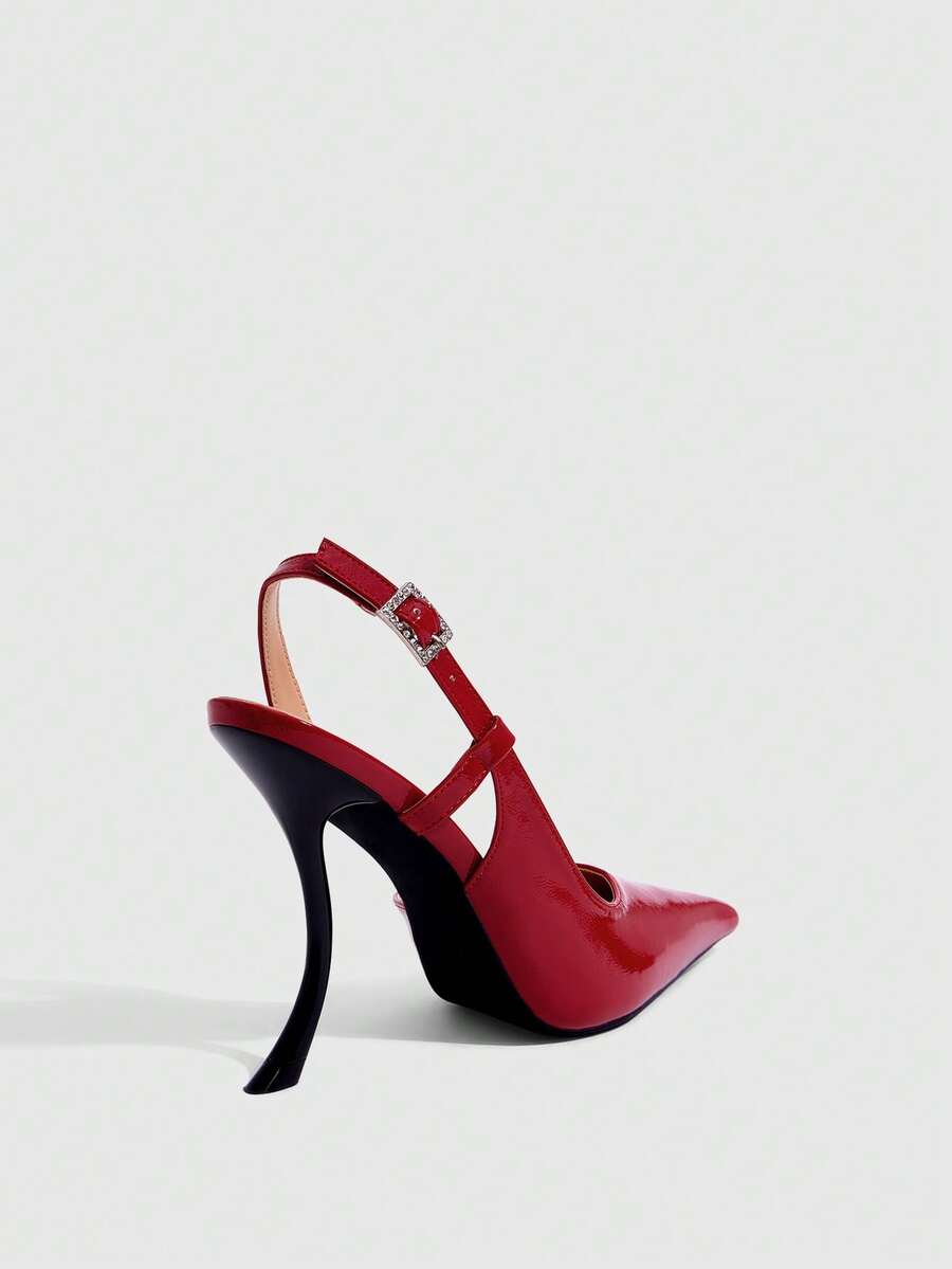 Red women's pointed-toe high heel sandals featuring a sculptural heel, rear slingback strap, and decorative buckle detail.