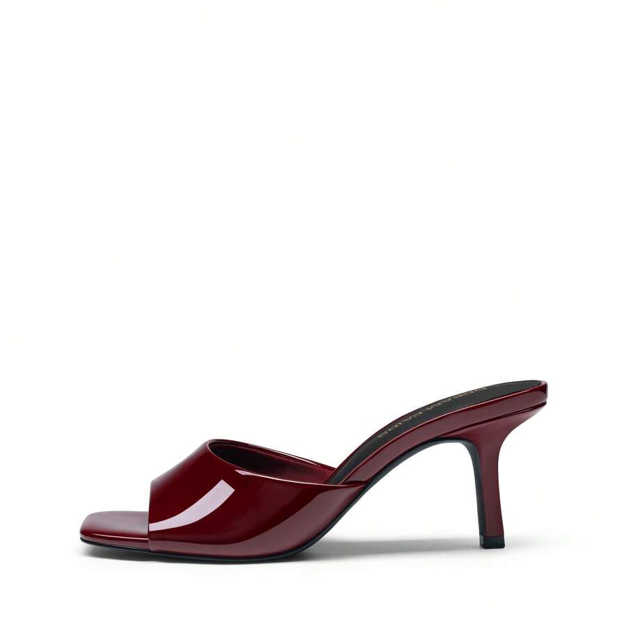 Pair of women's open square toe kitten heel mule sandals in white PU leather with slip-on styling.