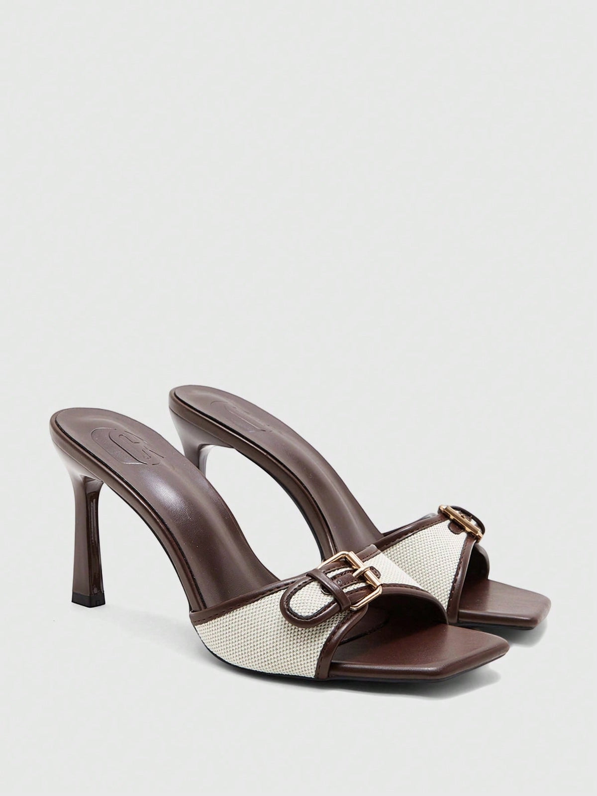 Women's brown open-toe slingback heeled sandals with stiletto heel and buckle strap.