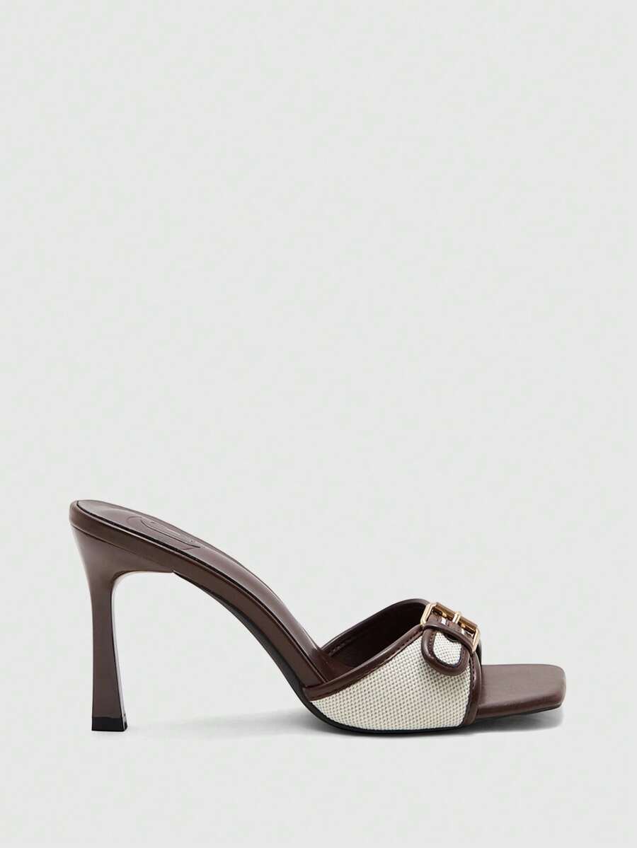Women's brown open-toe slingback heeled sandals with stiletto heel and buckle strap.
