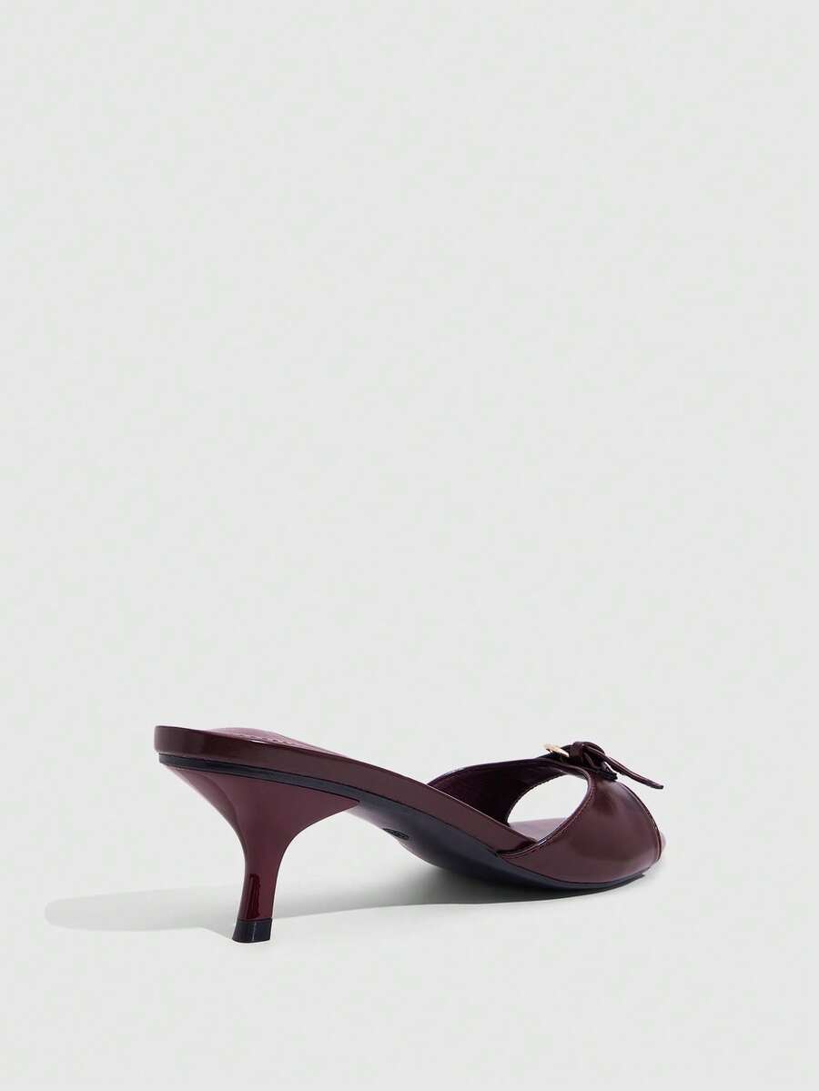 Women's light gold kitten heel slingback sandals featuring an open toe and round buckle strap.
