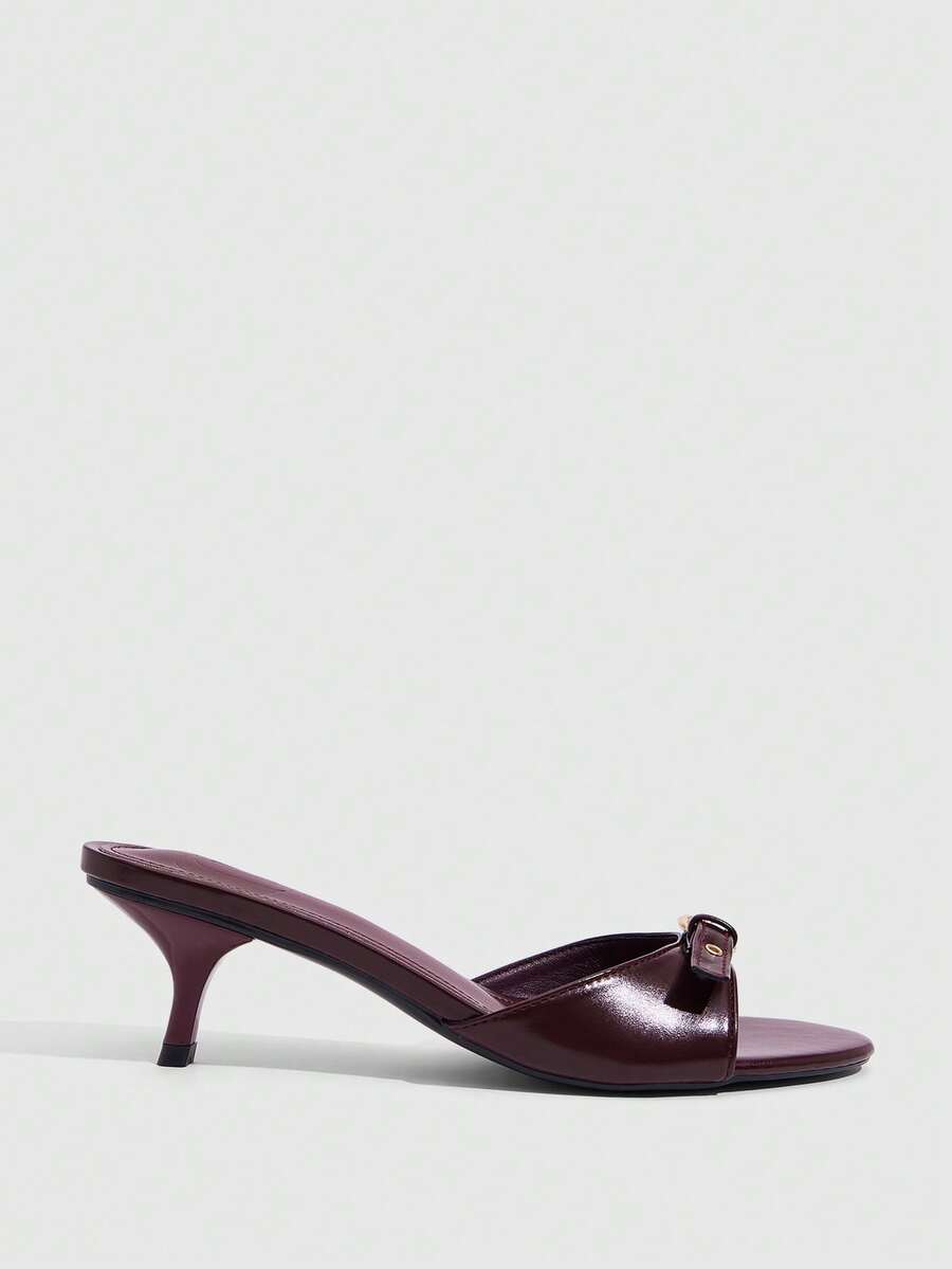 Women's light gold kitten heel slingback sandals featuring an open toe and round buckle strap.