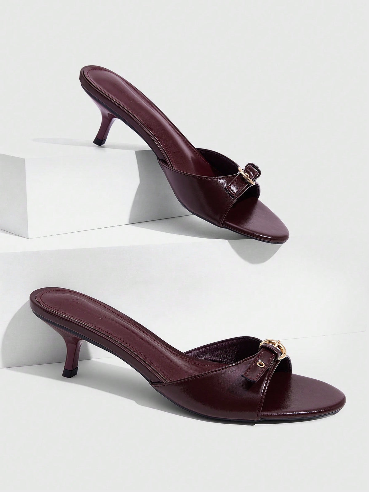 Women's light gold kitten heel slingback sandals featuring an open toe and round buckle strap.