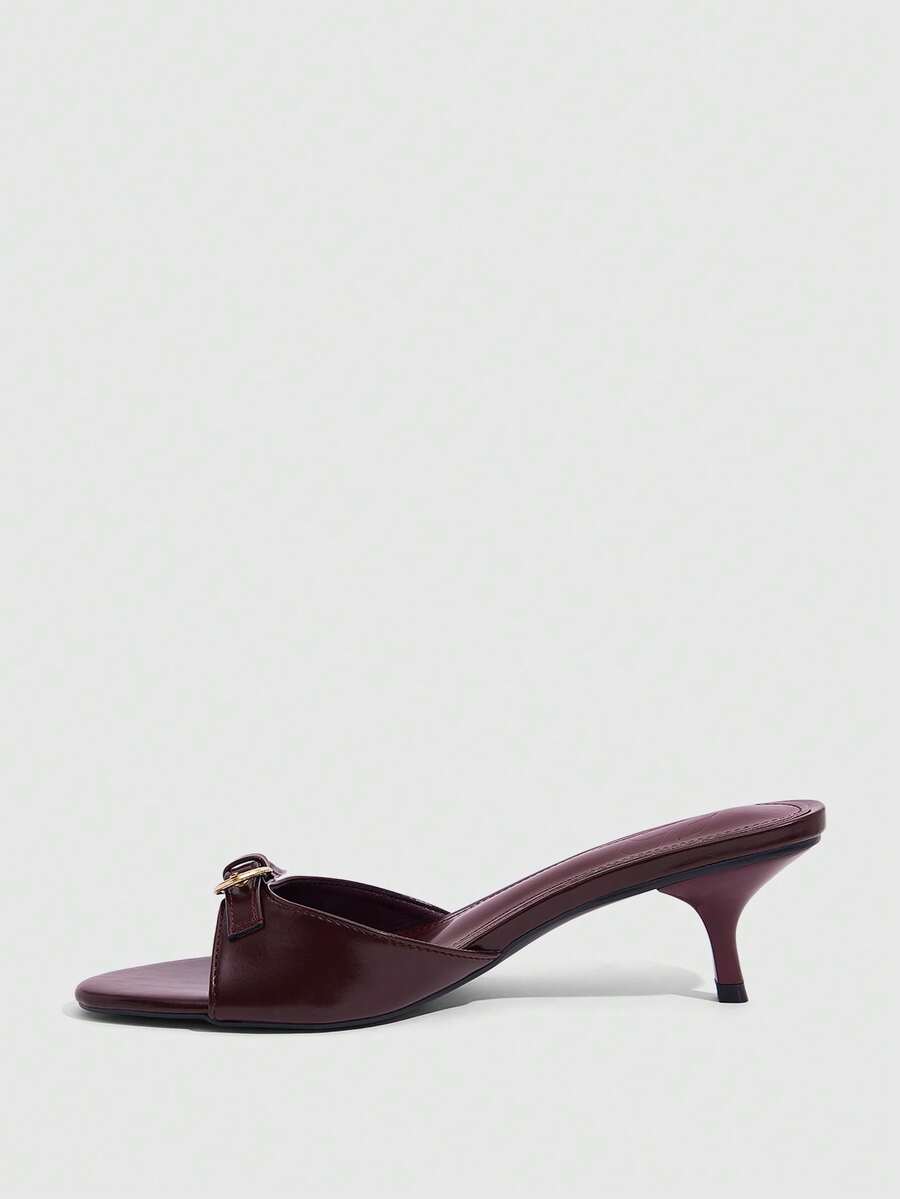 Women's light gold kitten heel slingback sandals featuring an open toe and round buckle strap.