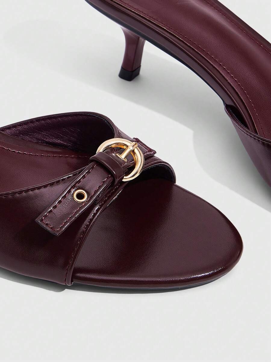 Women's light gold kitten heel slingback sandals featuring an open toe and round buckle strap.