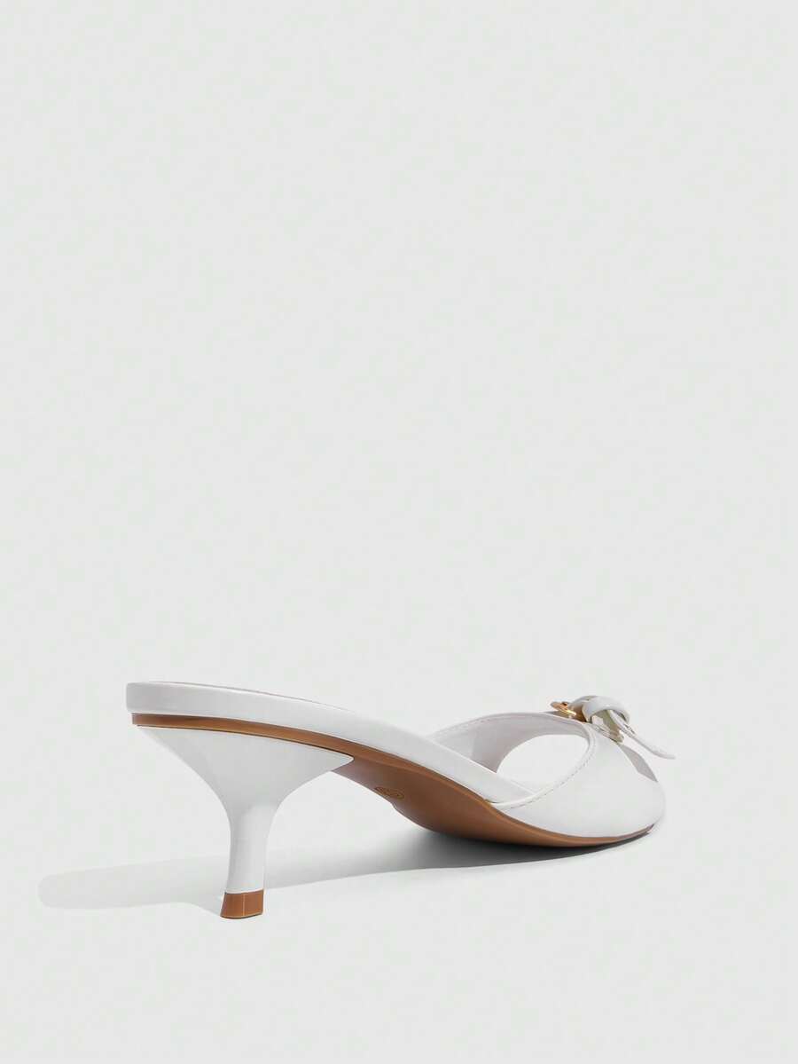 Women's light gold kitten heel slingback sandals featuring an open toe and round buckle strap.