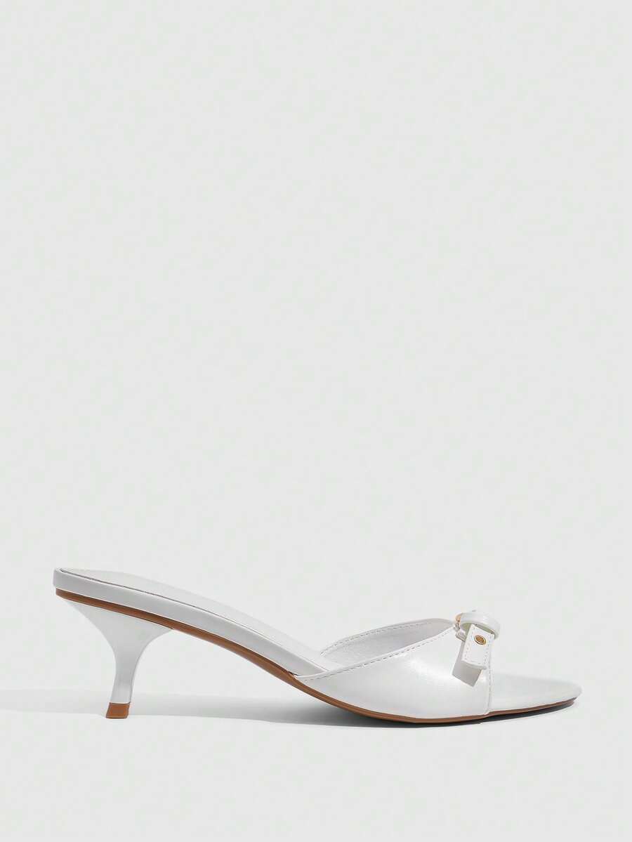 Women's light gold kitten heel slingback sandals featuring an open toe and round buckle strap.