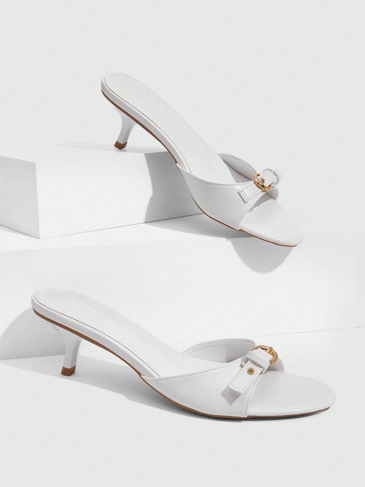 Women's light gold kitten heel slingback sandals featuring an open toe and round buckle strap.