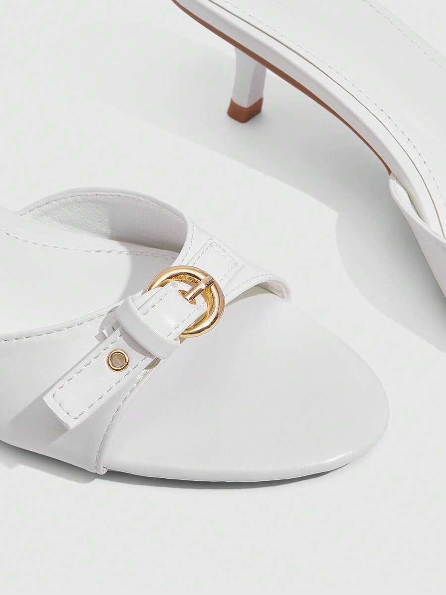 Women's light gold kitten heel slingback sandals featuring an open toe and round buckle strap.