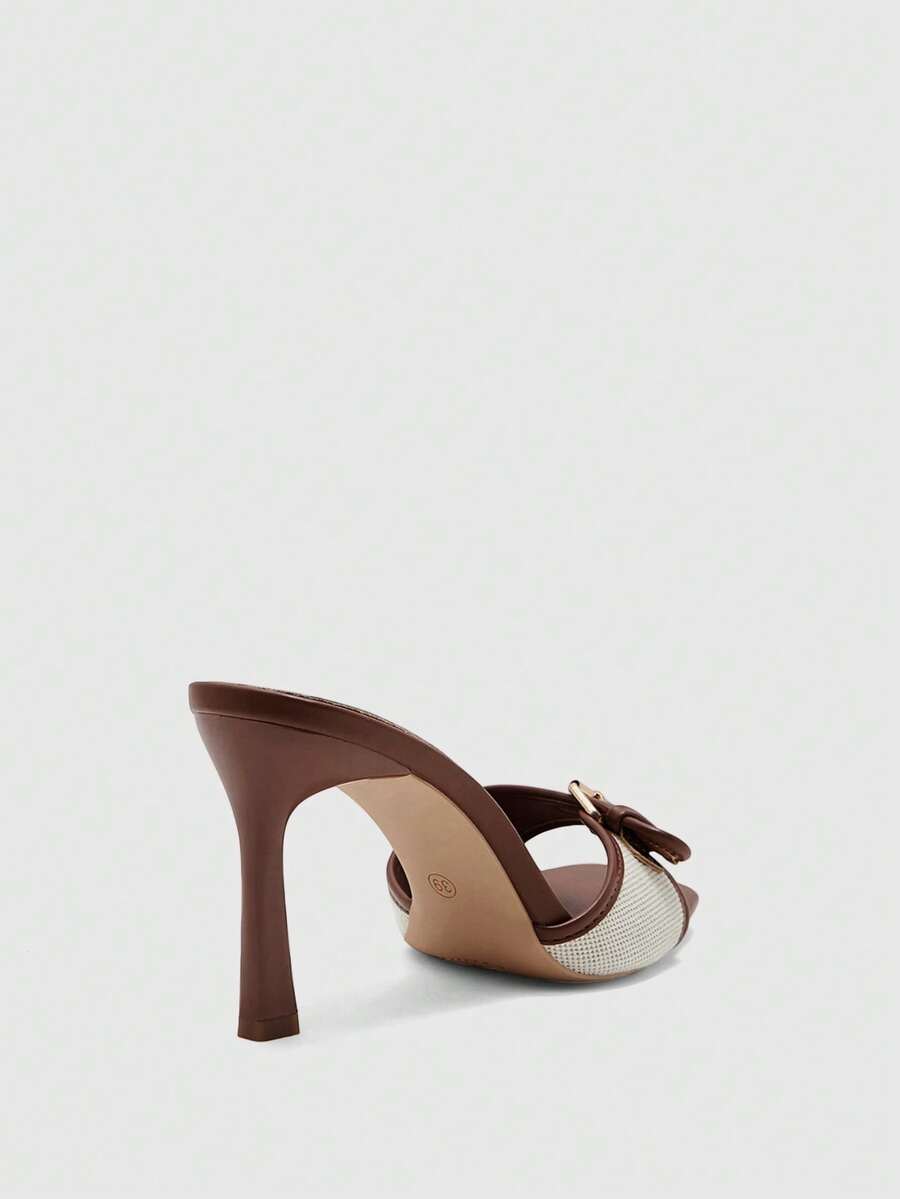 Women's brown open-toe slingback heeled sandals with stiletto heel and buckle strap.