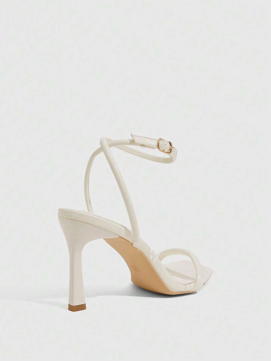 Women's high heel ankle strap sandals with open toe and stiletto heel in mirror black finish.