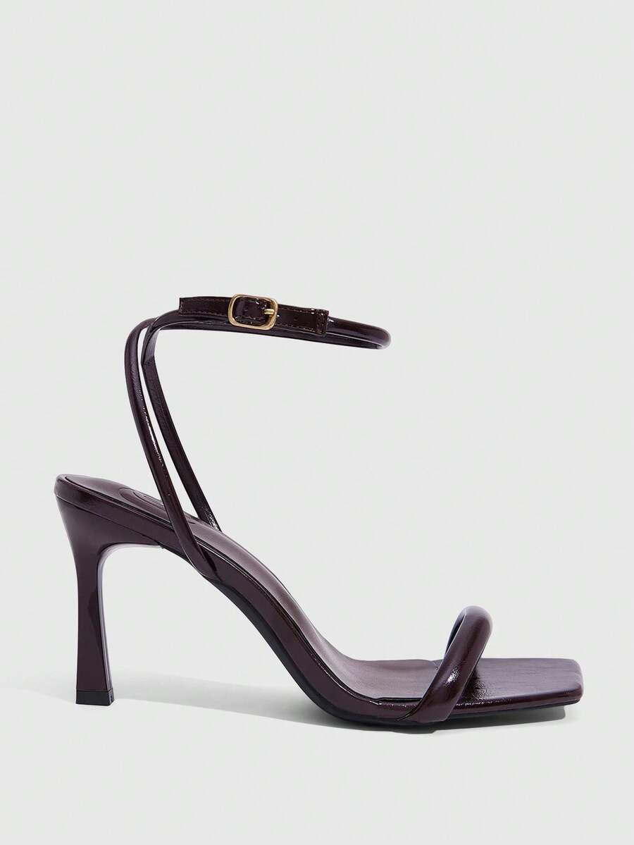 Women's high heel ankle strap sandals with open toe and stiletto heel in mirror black finish.