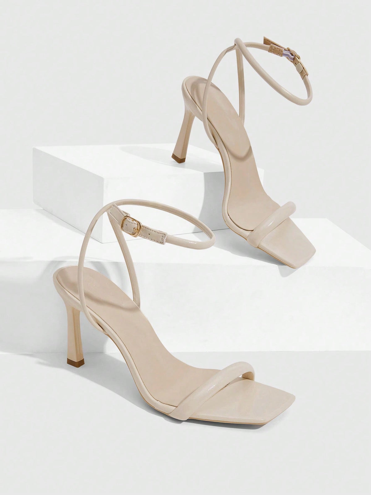 Women's high heel ankle strap sandals with open toe and stiletto heel in mirror black finish.