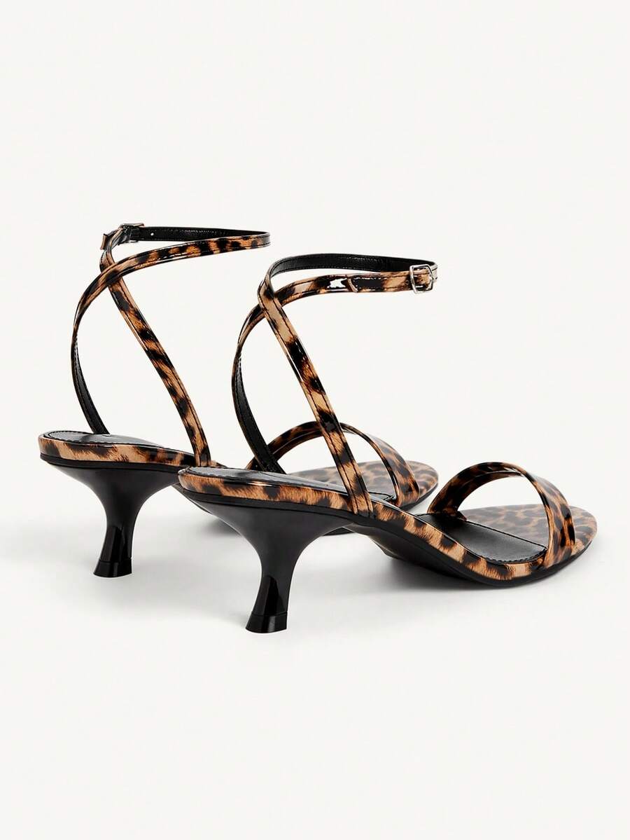 Women's open-toed high-heeled sandals featuring a 5.5cm kitten heel stiletto, sleek ankle strap with buckle closure, and smooth PU leather finish.
