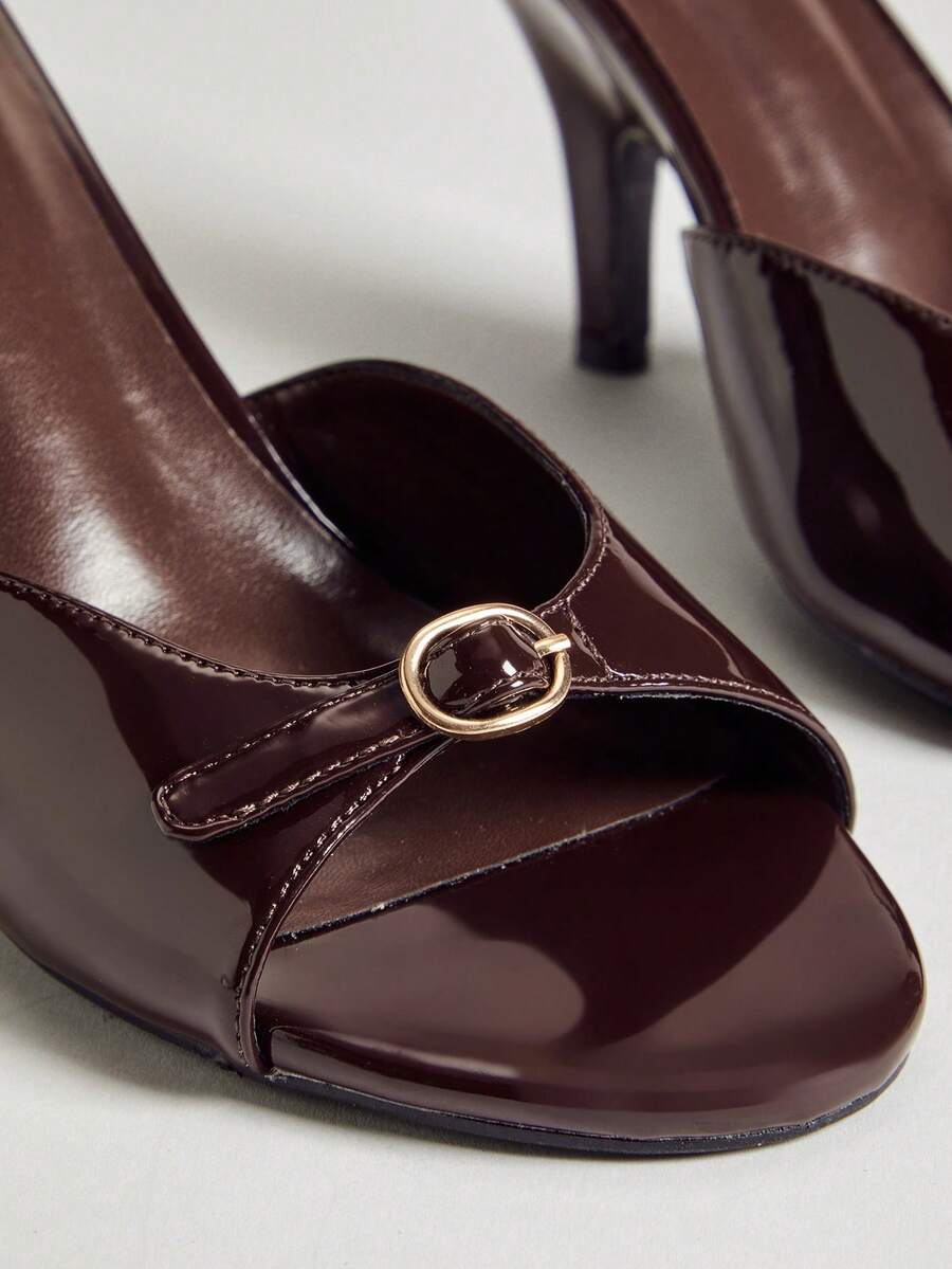 Women's slip-on heeled sandals with metal-coated stiletto heels and lock decoration in chocolate brown PU leather.