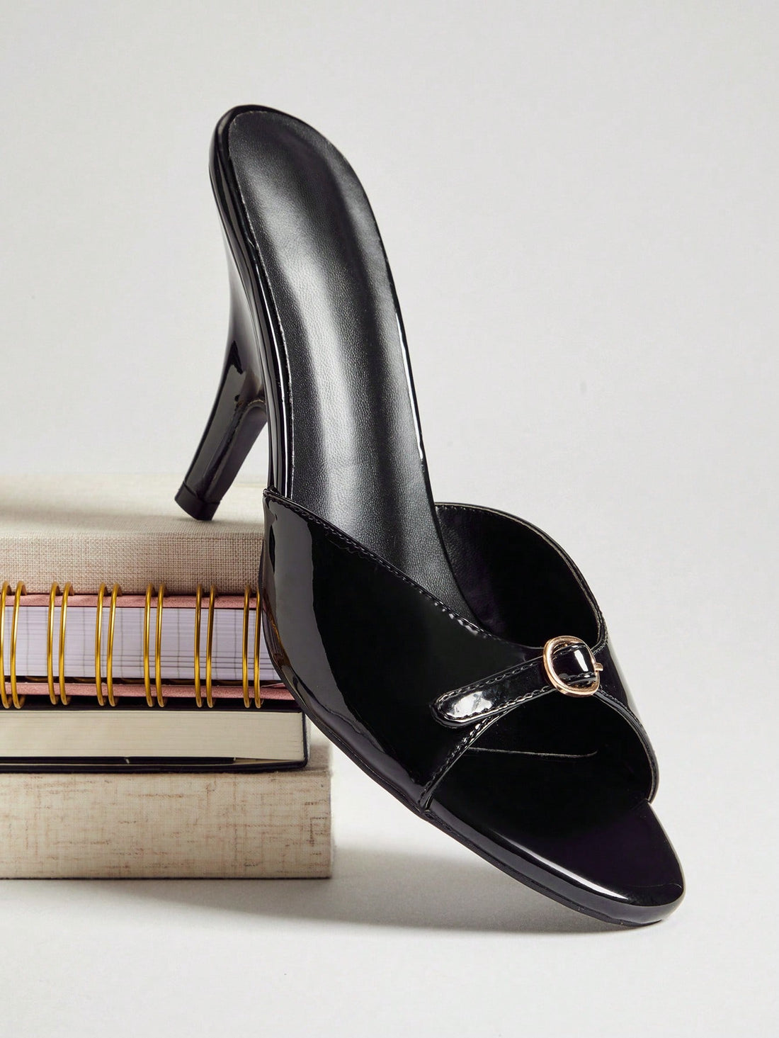 Women's slip-on heeled sandals with metal-coated stiletto heels and lock decoration in chocolate brown PU leather.