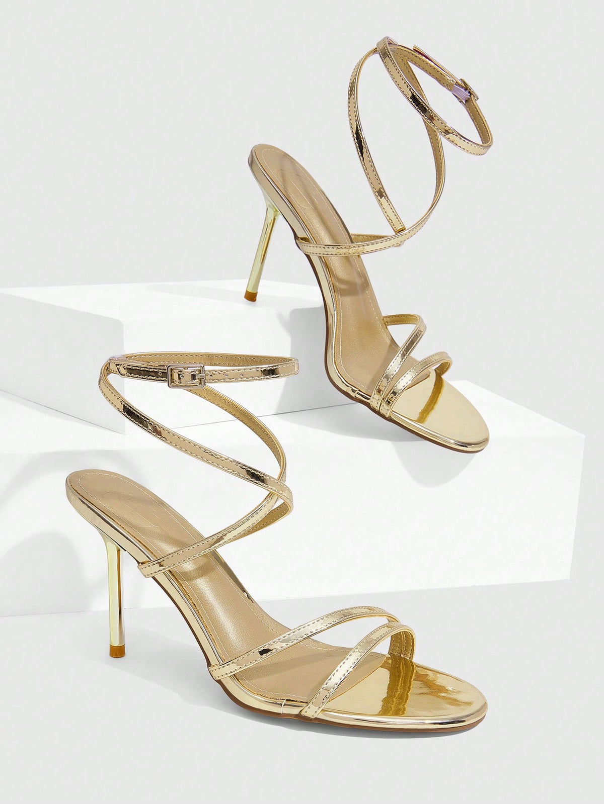 Women's square toe stiletto high heeled sandals with ankle strap buckle in a sleek faux leather finish.
