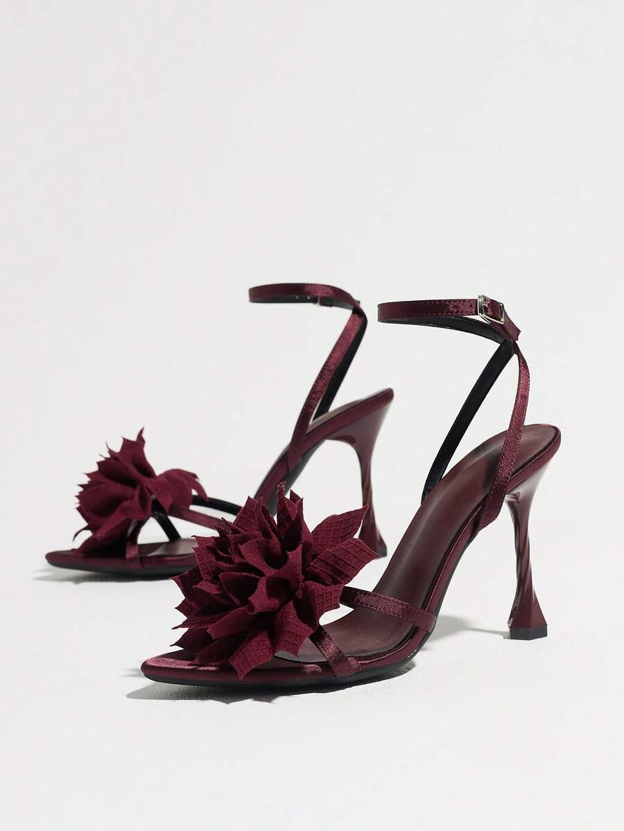 Women's black open toe stiletto heel sandals featuring lace mesh detailing, wide strap styling, and high stiletto heels.