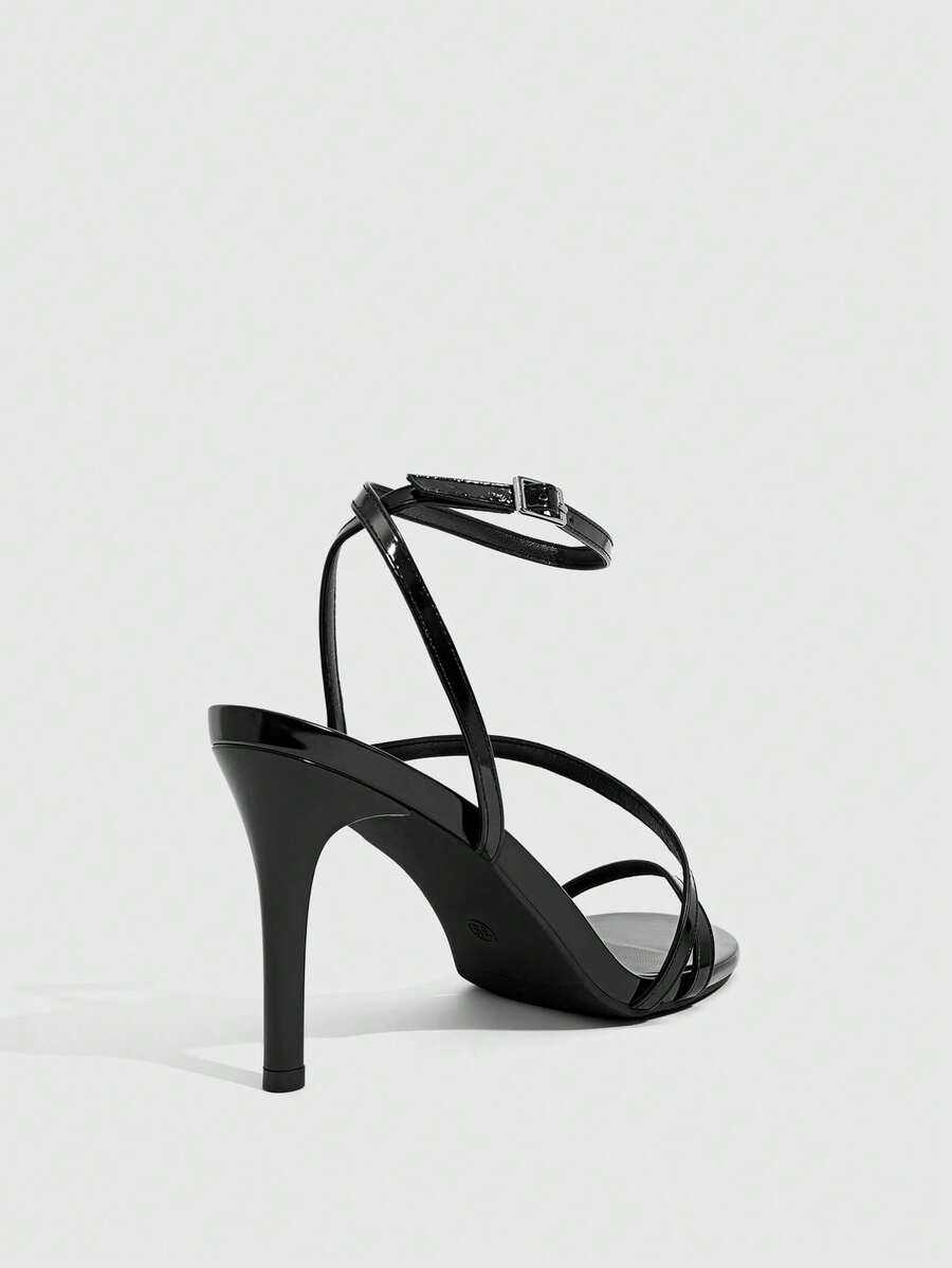 Women's silver stiletto high-heeled sandals with cross straps, buckle fastening, and open round toe.
