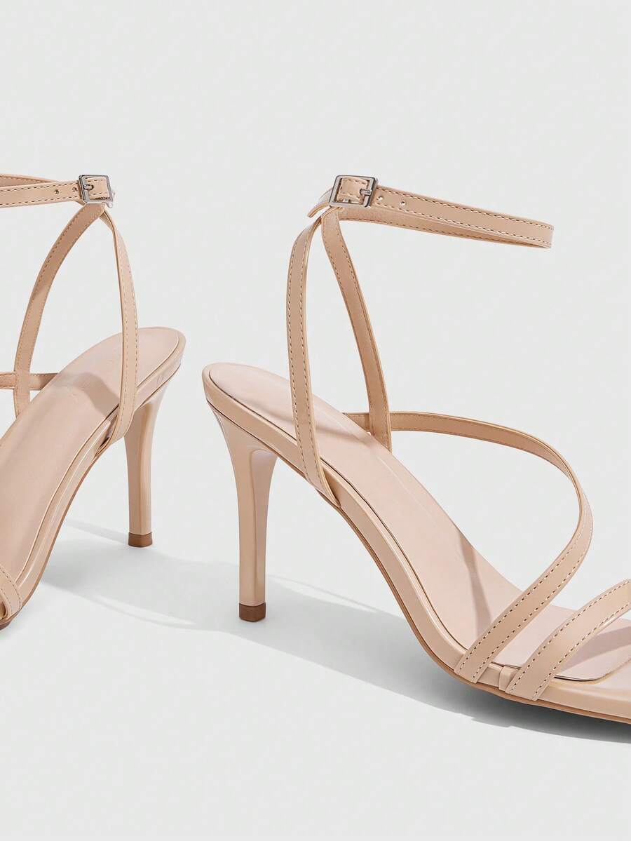 Women's silver stiletto high-heeled sandals with cross straps, buckle fastening, and open round toe.