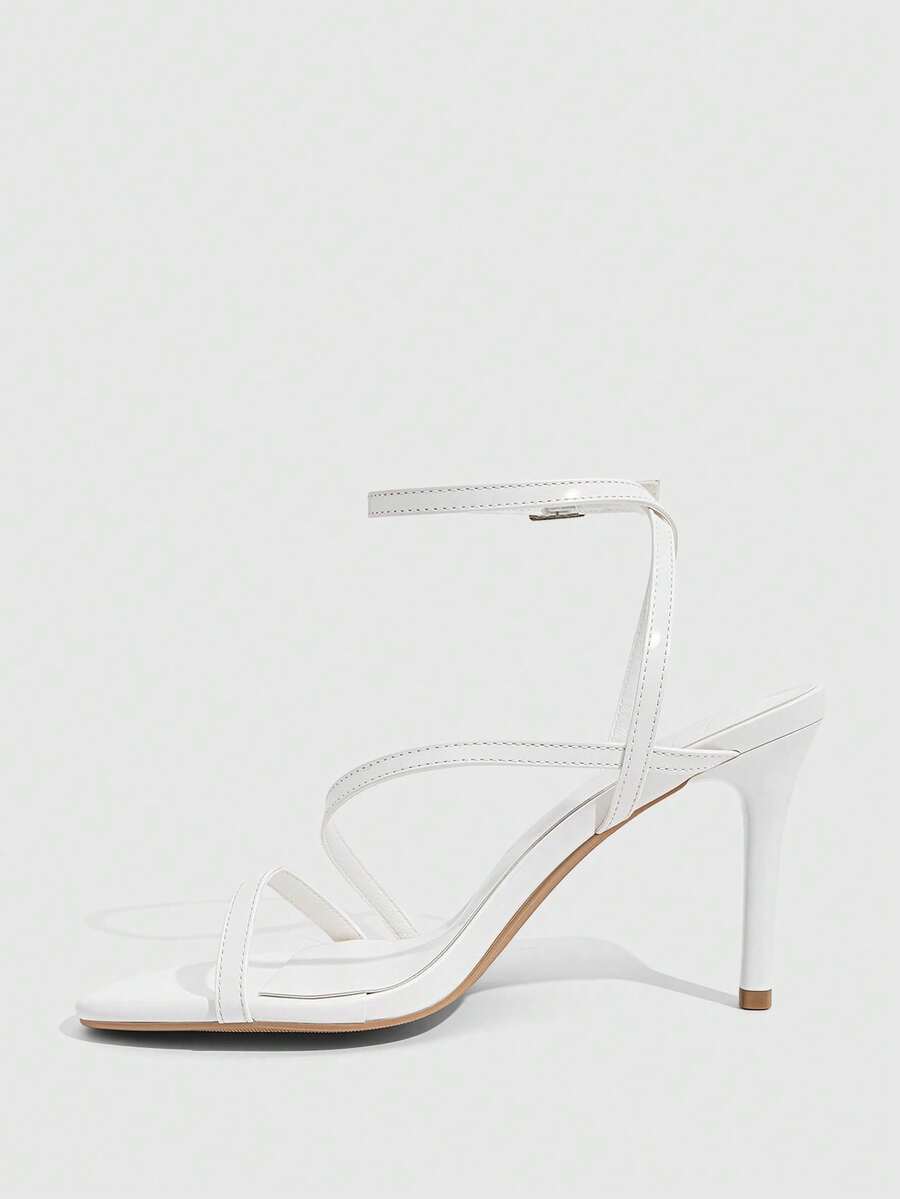 Women's silver stiletto high-heeled sandals with cross straps, buckle fastening, and open round toe.