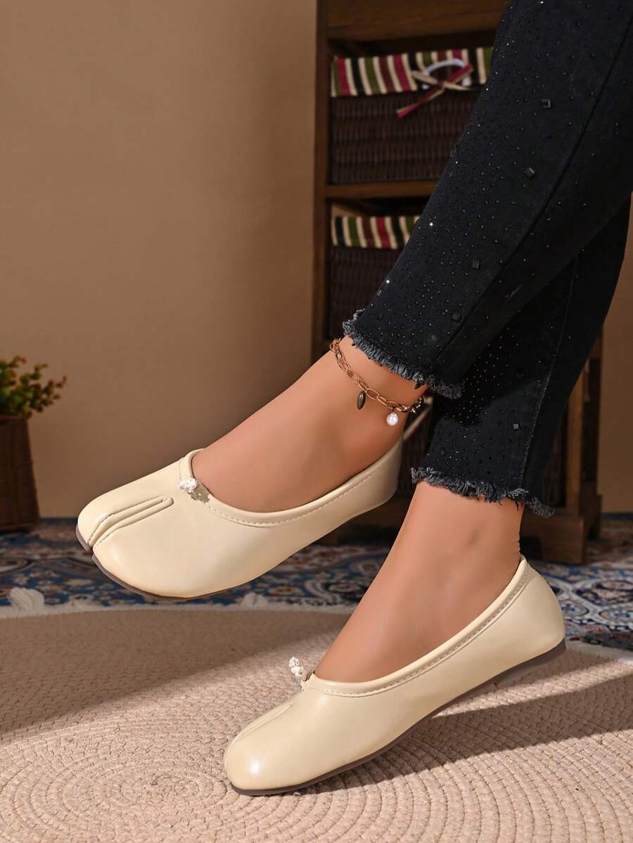 Women's white split-toe slip-on flat shoes with braided accent and rubber sole