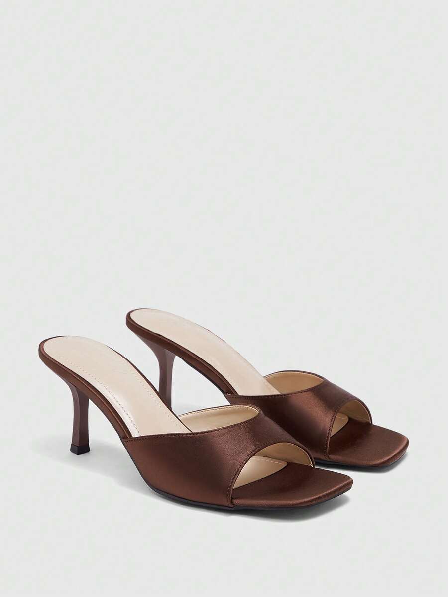 Women's black square toe high heel sandals featuring an open toe design, thin stiletto heel, and slingback strap.