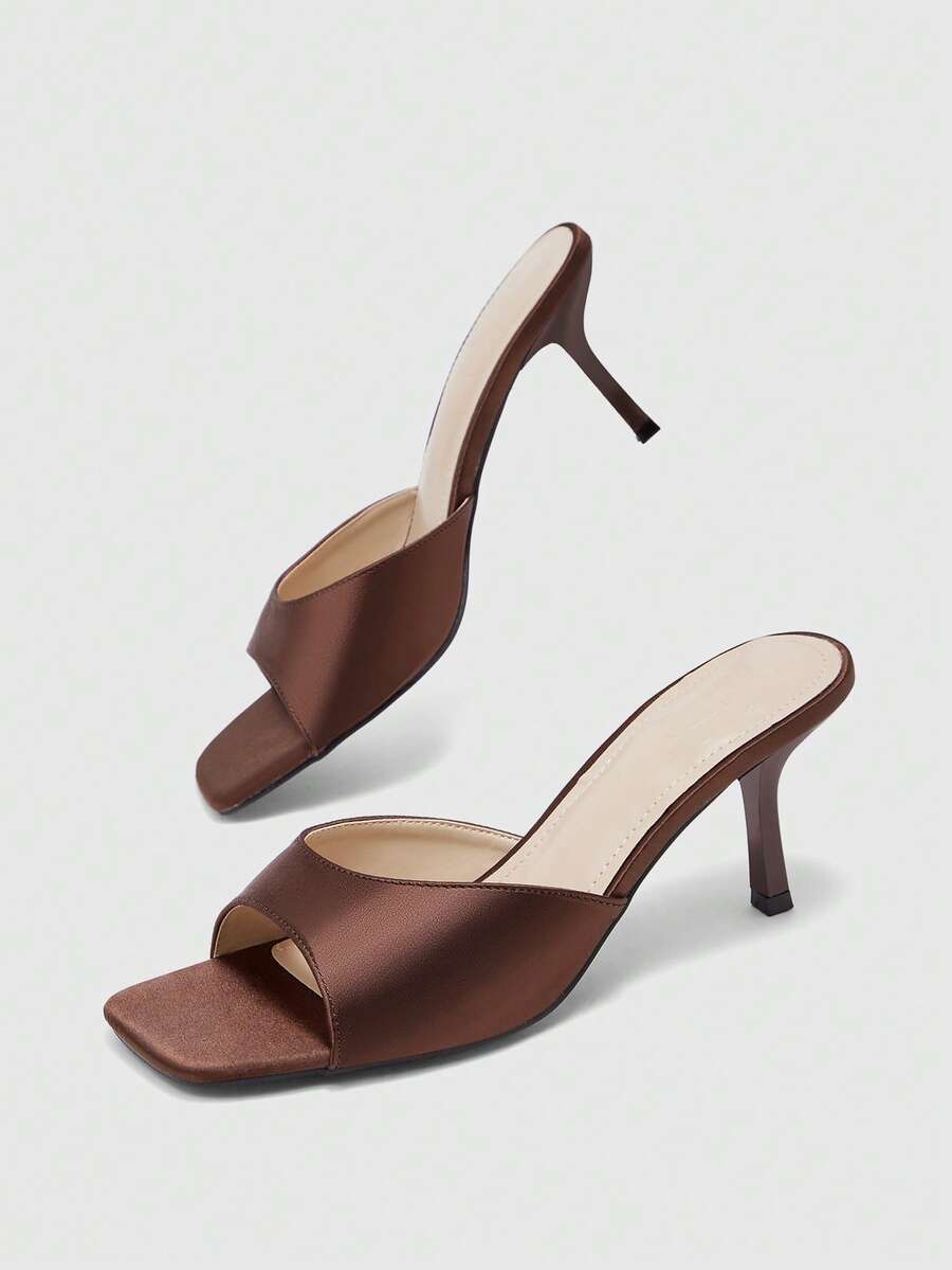 Women's black square toe high heel sandals featuring an open toe design, thin stiletto heel, and slingback strap.
