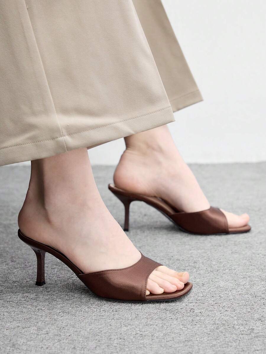Women's black square toe high heel sandals featuring an open toe design, thin stiletto heel, and slingback strap.