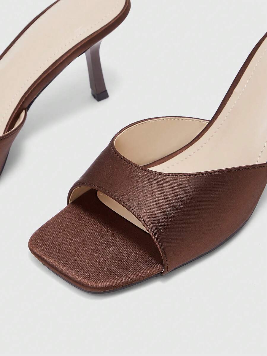 Women's black square toe high heel sandals featuring an open toe design, thin stiletto heel, and slingback strap.