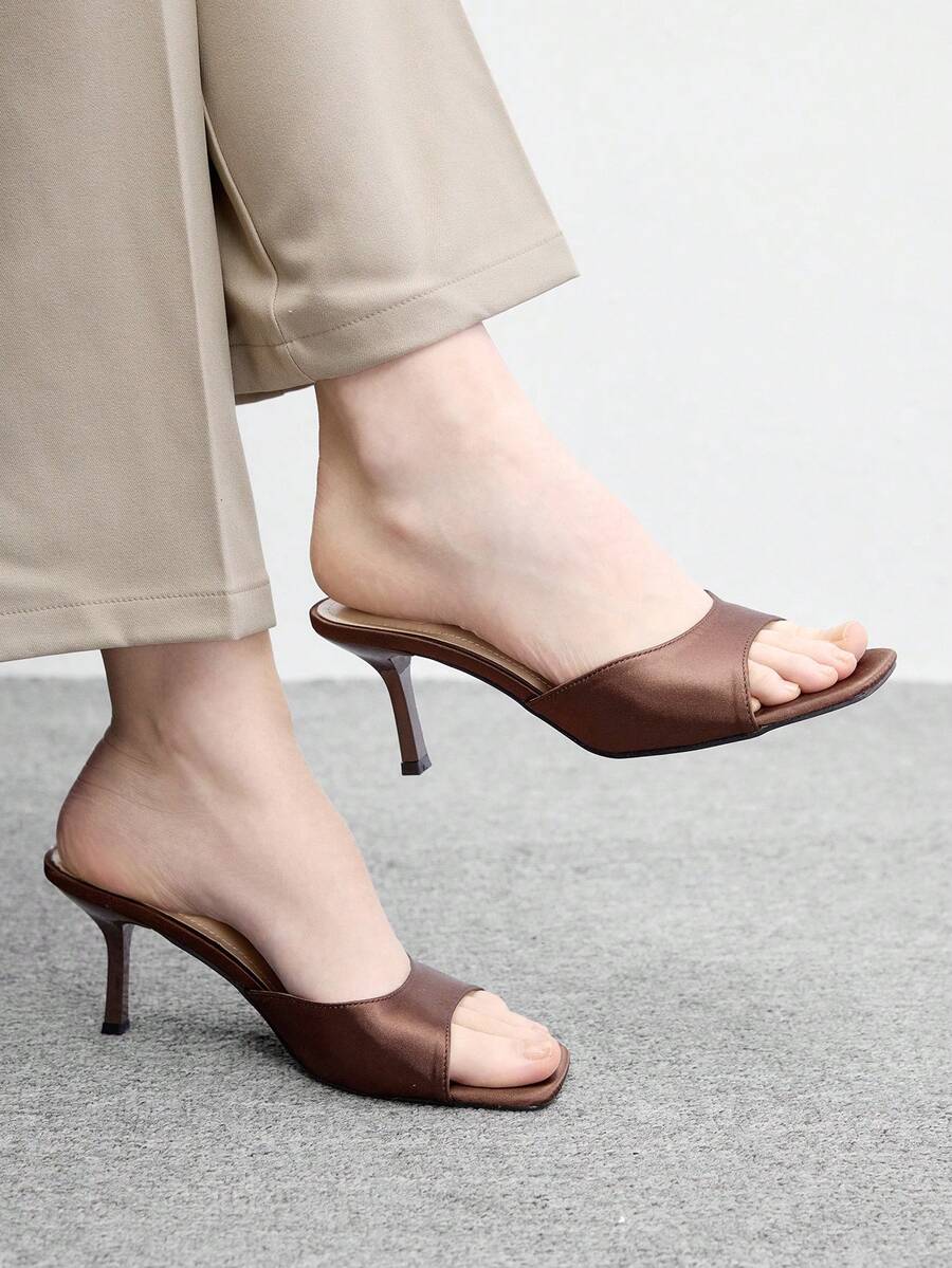 Women's black square toe high heel sandals featuring an open toe design, thin stiletto heel, and slingback strap.