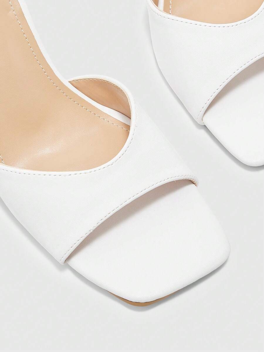 Women's black square toe high heel sandals featuring an open toe design, thin stiletto heel, and slingback strap.