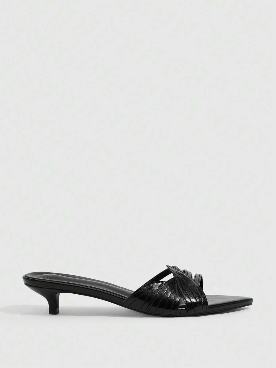 Pointed toe high-heeled slippers in PU leather with decorative buckle detail and low kitten heels for women.