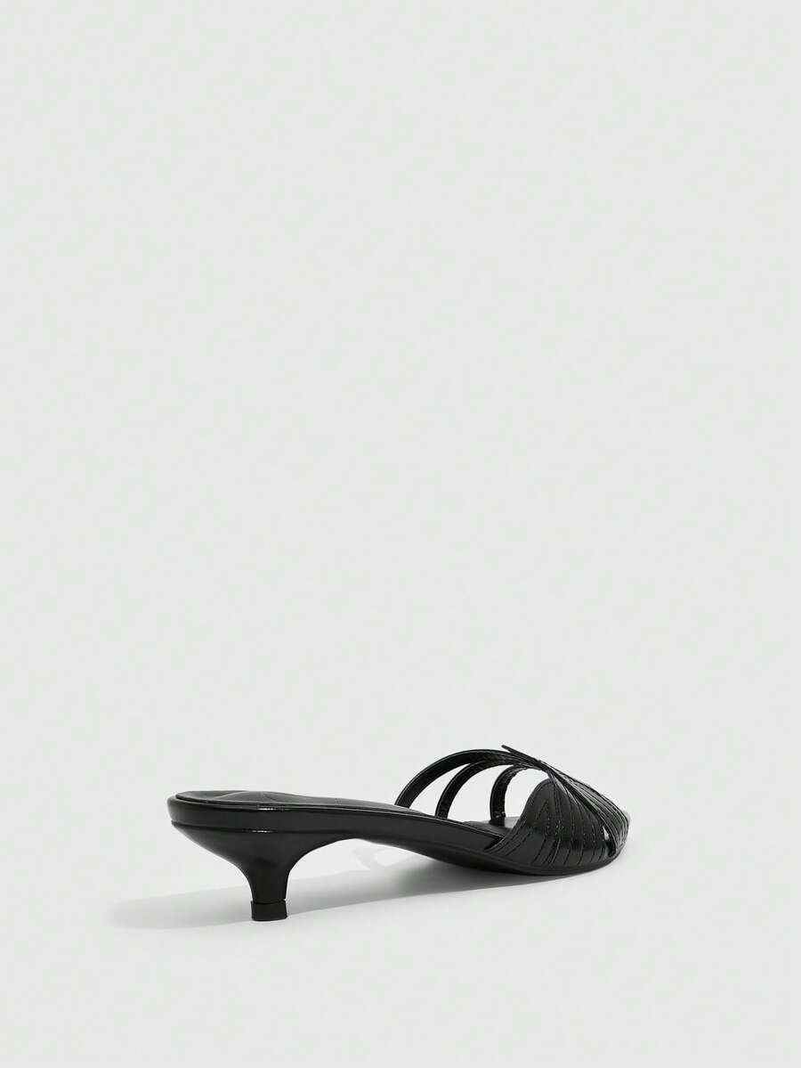 Pointed toe high-heeled slippers in PU leather with decorative buckle detail and low kitten heels for women.
