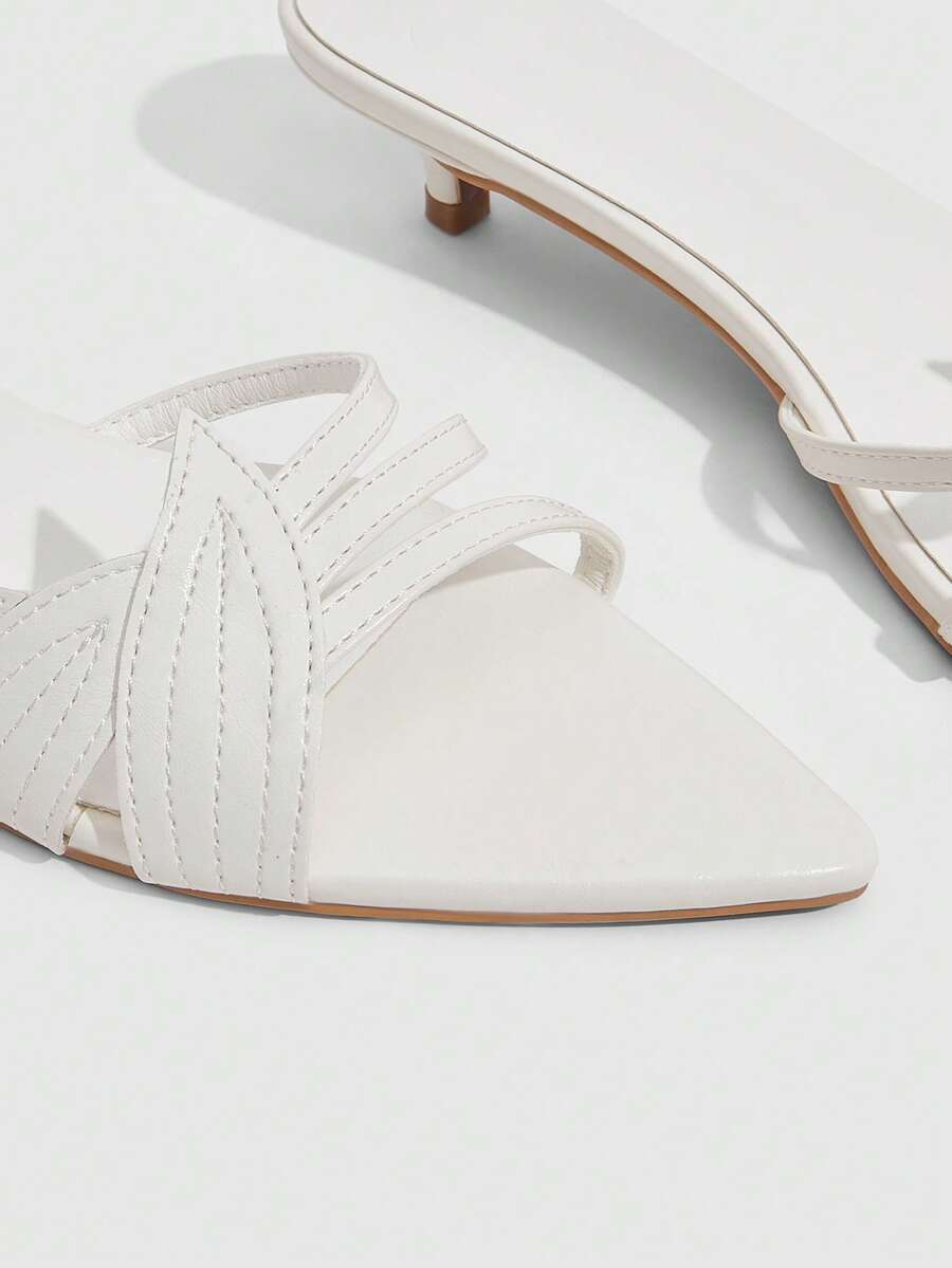 Pointed toe high-heeled slippers in PU leather with decorative buckle detail and low kitten heels for women.