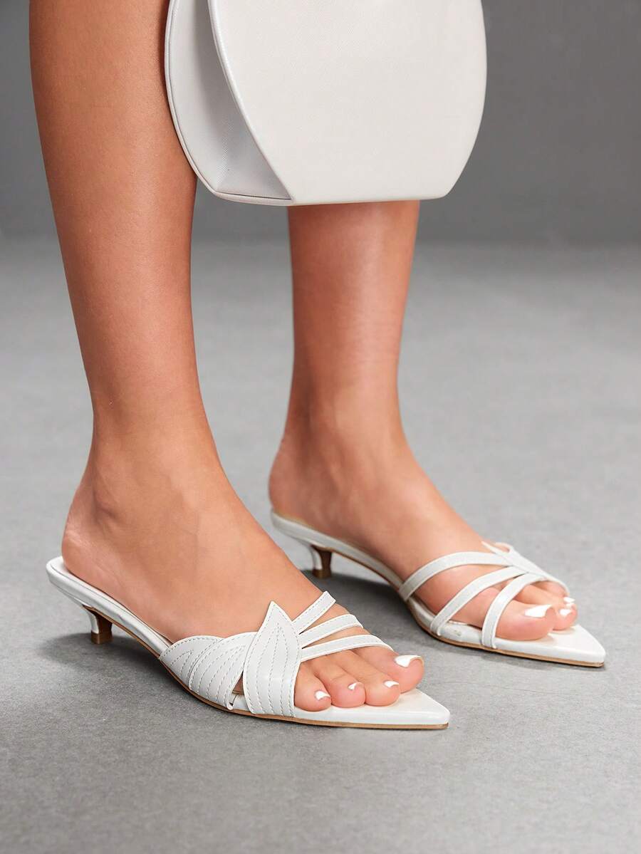 Pointed toe high-heeled slippers in PU leather with decorative buckle detail and low kitten heels for women.