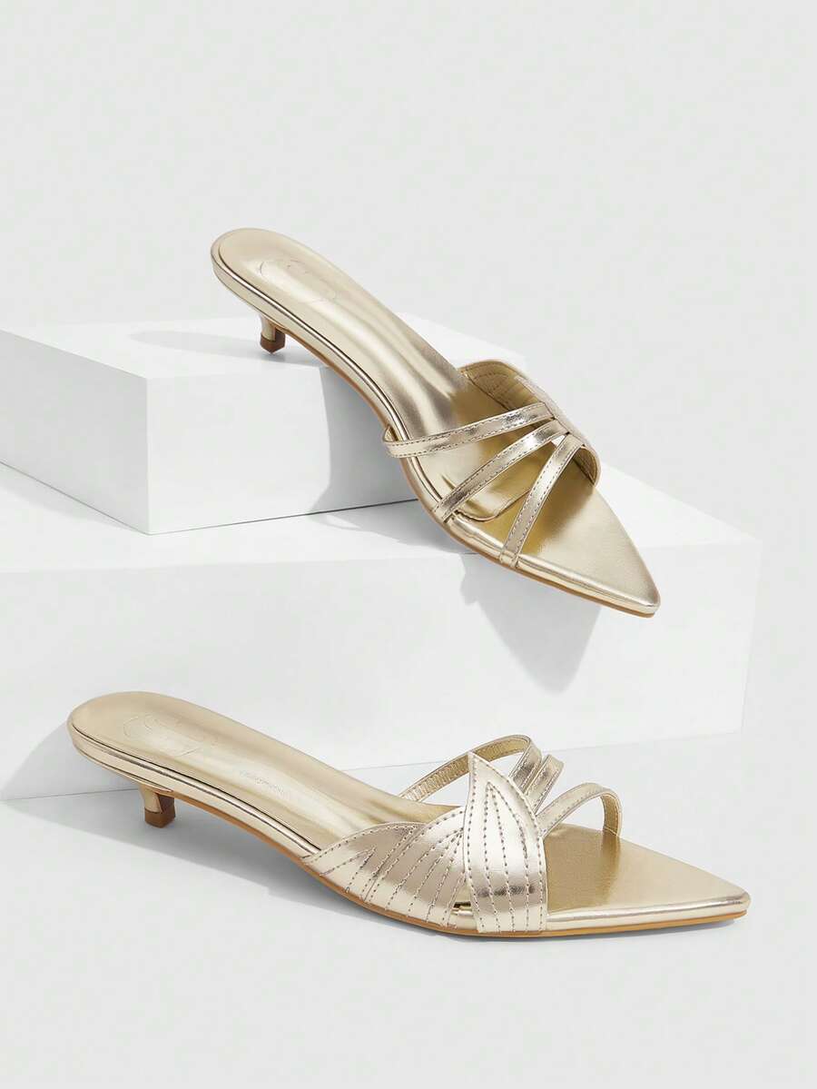 Pointed toe high-heeled slippers in PU leather with decorative buckle detail and low kitten heels for women.