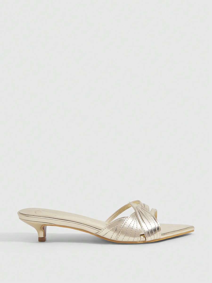 Pointed toe high-heeled slippers in PU leather with decorative buckle detail and low kitten heels for women.