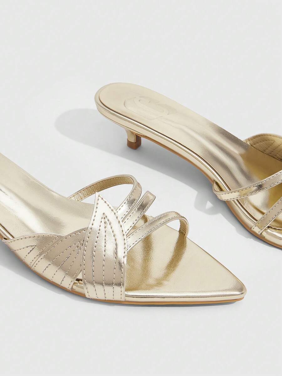 Pointed toe high-heeled slippers in PU leather with decorative buckle detail and low kitten heels for women.