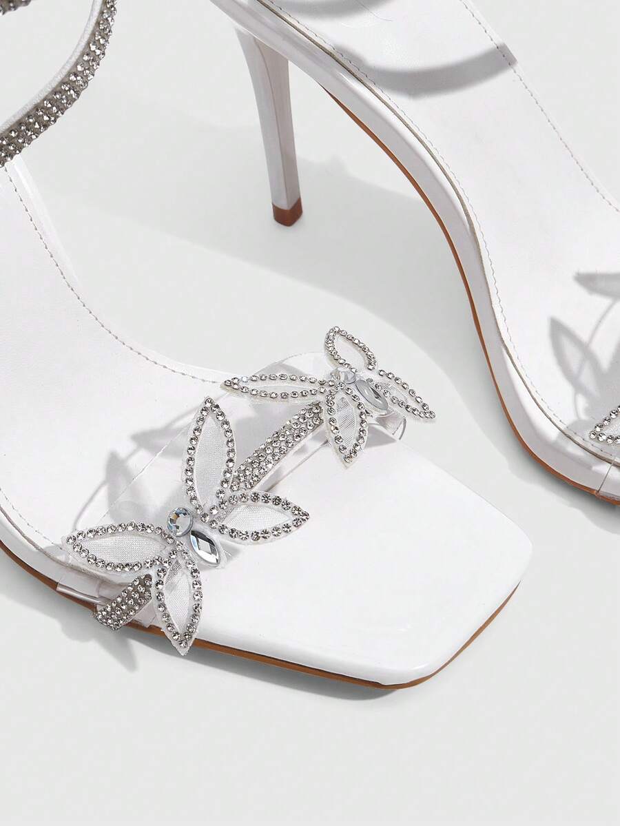 Women's square toe high heel slingback sandals featuring sparkling rhinestone floral accents, an open toe design, and sleek stiletto heels for summer parties.