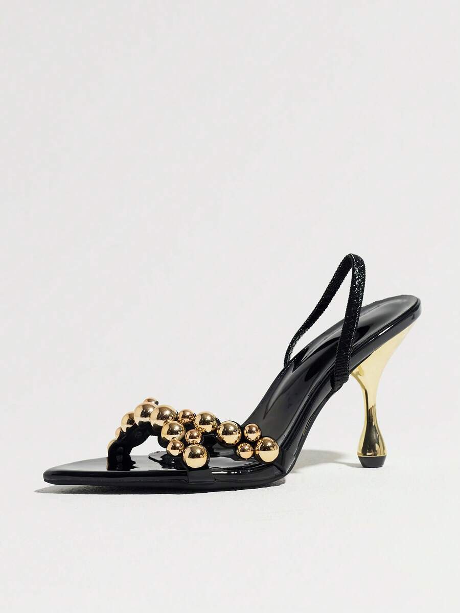 Pointed toe party high heels in gold featuring wavy lace trim, a stiletto heel, and back tie slingback straps.
