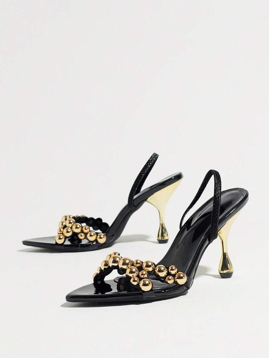 Pointed toe party high heels in gold featuring wavy lace trim, a stiletto heel, and back tie slingback straps.