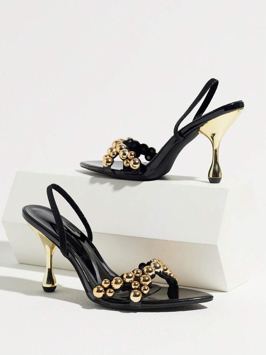Pointed toe party high heels in gold featuring wavy lace trim, a stiletto heel, and back tie slingback straps.