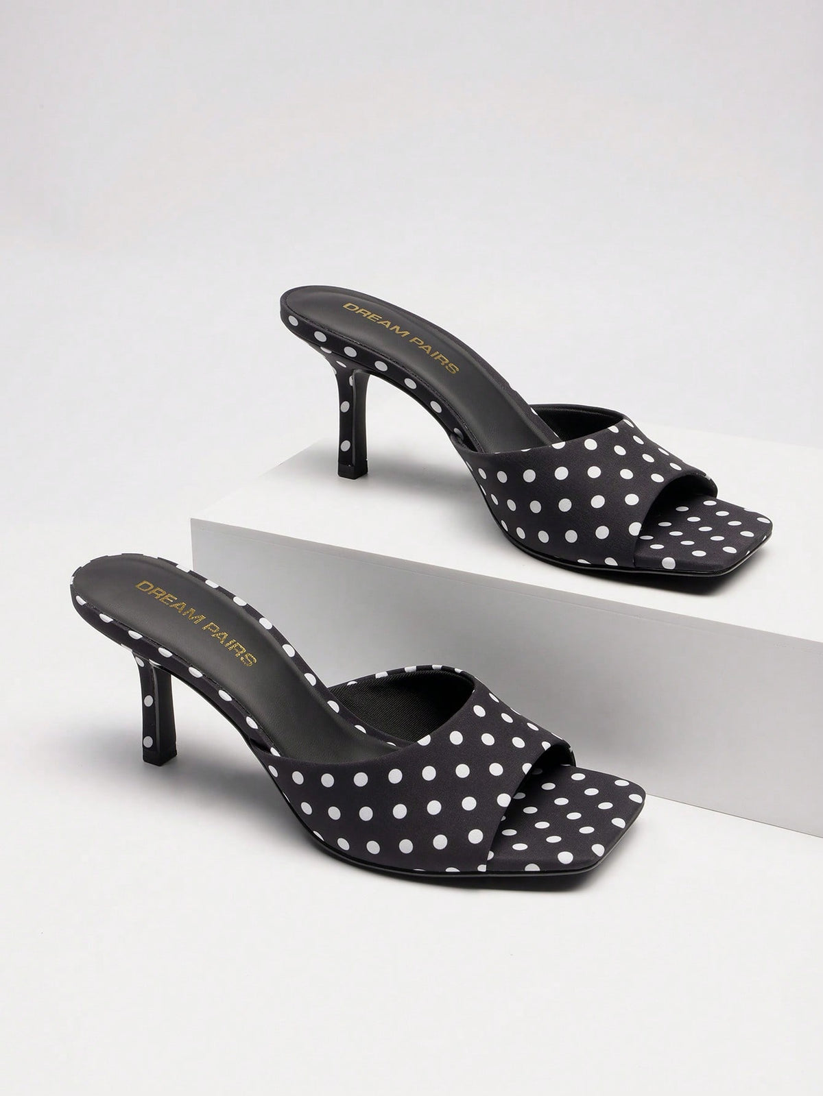 Pair of women's open square toe kitten heel mule sandals in white PU leather with slip-on styling.